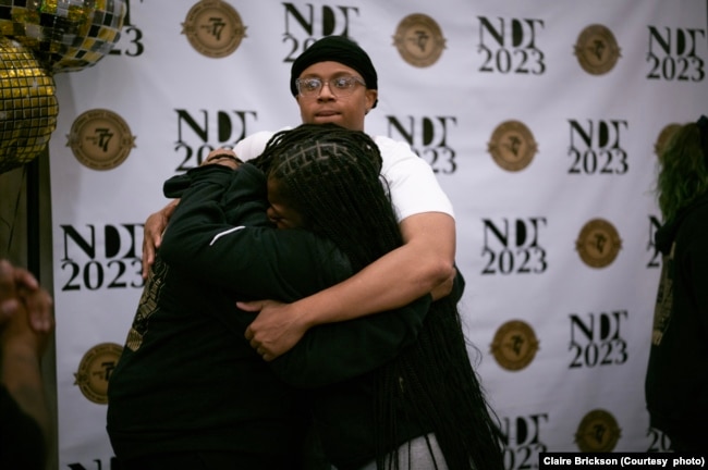 Tajaih Robinson of Wake Forest University hugs teammate Iyana Trotman and associate coach Amber Kelsie after winning the National Debate Tournament in Chantilly, Virginia, Tuesday, April 4, 2023. (Photo courtesy of Claire Brickson)