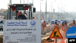 FILE - Asian laborers of the Saudi National Water Company working at a construction site in a road in the capital Riyadh. Saudi Arabia. (Fayez Nureldine / AFP)