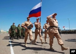 FILE - Russian soldiers participate in a joint exercise by the Shanghai Cooperation Organization in Khujand, Tajikistan, June 9, 2012. The drill involved personnel from China, Russia, Kazakhstan, Kyrgyzstan, Tajikistan and Uzbekistan. (Xinhua via AP)