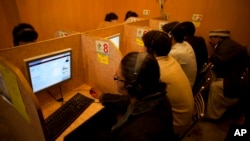 FILE - People use the internet at a local cafe in Islamabad, Pakistan, March 7, 2012. Pakistan said July 26, 2024, that it is implementing an internet firewall, which critics and digital rights activists worry will be used to silence dissent.