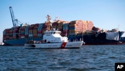 This image provided by the U.S. Coast Guard shows the U.S. Coast Guard Cutter Sailfish, as it prepares to escort the cargo ship Dali during its transit from the Port of Baltimore to the Port of Virginia, June 24, 2024.