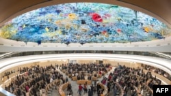 Delegates stand for a minute of silence following the deadly 6.8-magnitude Sept. 8 earthquake, in central Morocco, at the opening of the 54th UN Human Rights Council in Geneva, on Sept. 11, 2023. 