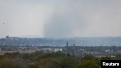 Smoke rises above the area of Avdiivka town in the course of Russia-Ukraine conflict, as seen from Yasynuvata (Yasinovataya) in the Donetsk region, Russian-controlled Ukraine, Oct. 13, 2023. 