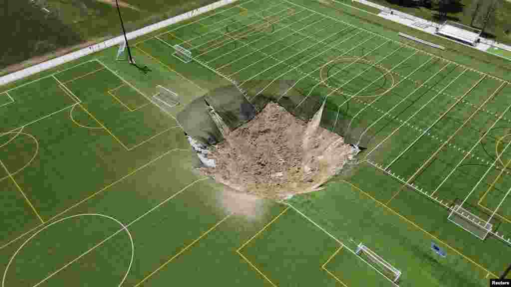A drone view shows a sinkhole that formed on a turf soccer field at Gordon Moore Park in Alton, Illinois, June 27, 2024. 