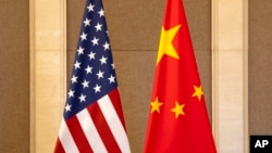 FILE - U.S. and Chinese flags are set up at the Diaoyutai State Guesthouse in Beijing, on July 8, 2023. 