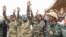 FILE - Nigerien military leaders wave to supporters at the General Seyni Kountche Stadium in Niamey, Niger, Aug. 26, 2023. 
