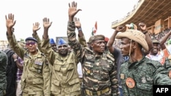 Nigerien military leaders wave to supporters at the General Seyni Kountche Stadium in Niamey, Niger, on Aug. 26, 2023. 