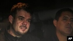 FILE - Dutch citizen Joran van der Sloot, left, is driven in a police vehicle from a maximum-security prison to an airport to be extradited to the U.S., on the outskirts of Lima, Peru, June 8, 2023.