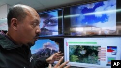 FILE - Paulino Alonso Rivera, who works at the National Center for Disaster Prevention of Mexico, gives an interview as he monitors the Popocatépetl volcano, in Mexico City, Feb. 8, 2023.