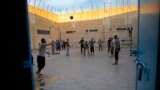 FILE - Prisoners play volleyball, in a Kurdish-run prison housing former members of the Islamic State group, in Qamishli, north Syria, April 3, 2018.