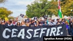 Pro-Palestinian protesters hold a banner with the inscription 'Cease-fire' as they make their way to the U.S. Capitol in Washington on Wednesday Oct. 18, 2023. 