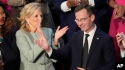 First lady Jill Biden applauds Sweden’s Prime Minister Ulf Kristersson, as President Joe Biden delivers the State of the Union address to a joint session of Congress at the US Capitol, March 7, 2024.