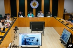 Philippine Coast Guard spokesman Commodore Jay Tarriela, second from right, shows a video of an incident involving a Chinese coast guard ship and a Philippine military-run supply boat at a press conference in Quezon City, Philippines, Oct. 23, 2023.