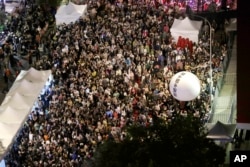 FILE - Supporters of the ruling Democratic Progressive Party gather and push a ball reading ''Reject China's Interference In Politics'' outside the legislative building in Taipei, Taiwan, May 28, 2024.