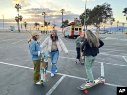 Yun Huang poses with her longboard in Santa Monica on Aug. 31, 2022. (Laura Paragano via AP)