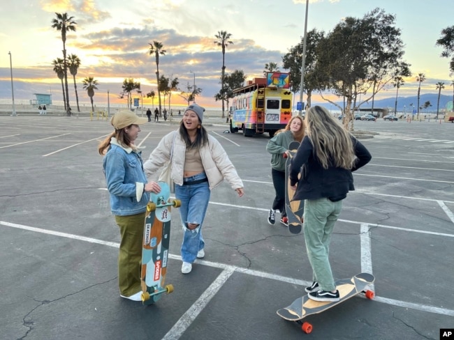 Yun Huang poses with her longboard in Santa Monica on Aug. 31, 2022. (Laura Paragano via AP)