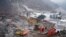 Rescue workers search for missing victims at a landslide site, a day after a landslide hits Liangshui village in Zhaotong, in southwestern China's Yunnan province on Jan. 23, 2024. (Photo by CNS / AFP)