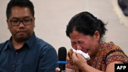 A Myanmar national reacts during a press conference after filing a criminal complaint in Manila, Philippines, Oct. 25, 2023. 