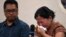 A Myanmar national reacts during a press conference after filing a criminal complaint in Manila, Philippines, Oct. 25, 2023. 