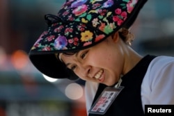 Yumeka Sakurai reacts during a rickshaw driving lesson from her colleagues in the Asakusa district, Tokyo, Aug. 17, 2023.
