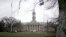 FILE - Students gather outside Old Main on the Penn State University main campus in State College, Pa., March 24, 2023.