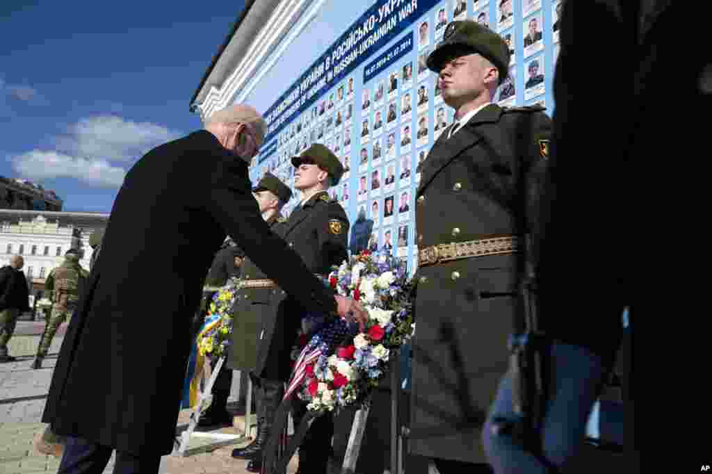 U.S. President Joe Biden participates in a wreath laying ceremony with Ukrainian President Volodymyr Zelenskyy at the memorial wall outside of St. Michael&#39;s Golden-Domed Cathedral in Kyiv, Feb. 20, 2023.