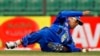 FILE - Afghanistan's Karim Sadiq dives to catch the ball while fielding during the Asia Cup one-day international cricket tournament against Pakistan in Fatullah, near Dhaka, Bangladesh, Feb. 27, 2014. 