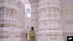 A woman admires the intricate architecture of the BAPS Swaminarayan Akshardham, the largest Hindu temple outside India in the modern era, Oct. 4, 2023, in Robbinsville, NJ.