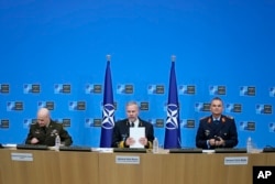 Chair of the NATO Military Committee Admiral Rob Bauer, center, Supreme Allied Commander Europe, General Christopher Cavoli, left, and Supreme Allied Commander Transformation General Chris Badia prepare to talk to the press in Brussels, Jan. 18, 2024.