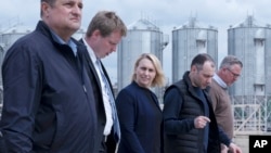 U.S. Ambassador to Ukraine Bridget Brink, center, walks with officials at a grain port in Izmail, Ukraine, April 26, 2023.