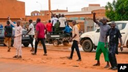 Nigerien men gather for an anti-French protest in Niamey, Niger, Aug. 11, 2023.