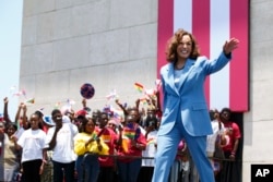 FILE - U.S. Vice President Kamala Harris waves as she arrives at Black Star square to address young people in Accra, Ghana, March 28, 2023. She'll be representing the United States at two key summits in Jakarta, Indonesia, in early September.
