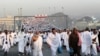 Thousands of Muslim pilgrims make their way to throw stones at a pillar