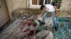 A boy looks at blood stains after a military raid in the Nur Shams refugee camp near the city of Tulkarem, in the occupied West Bank, May 6, 2023.