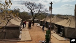 A camp where 95 Libyan nationals were arrested on suspicion of running an illegal military camp are seen lining up after their arrest on Friday July 26, 2024 in White River, South Africa.