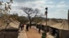 A camp where 95 Libyan nationals were arrested on suspicion of running an illegal military camp are seen lining up after their arrest on Friday July 26, 2024 in White River, South Africa.