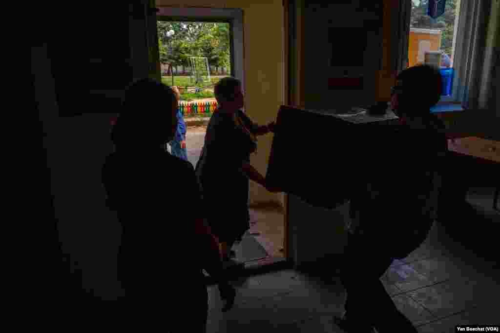 Workers of the Kupiansk, Ukraine post office load a truck carrying goods people are mailing out ahead of evacuations on Aug. 21, 2023 