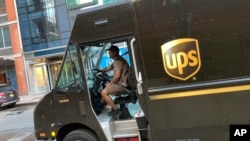 A United Parcel Service driver pilots his truck, in New York, May 11, 2023. More than 340,000 unionized UPS employees say they are prepared to strike if the company does not meet their demands before their contract ends July 31.