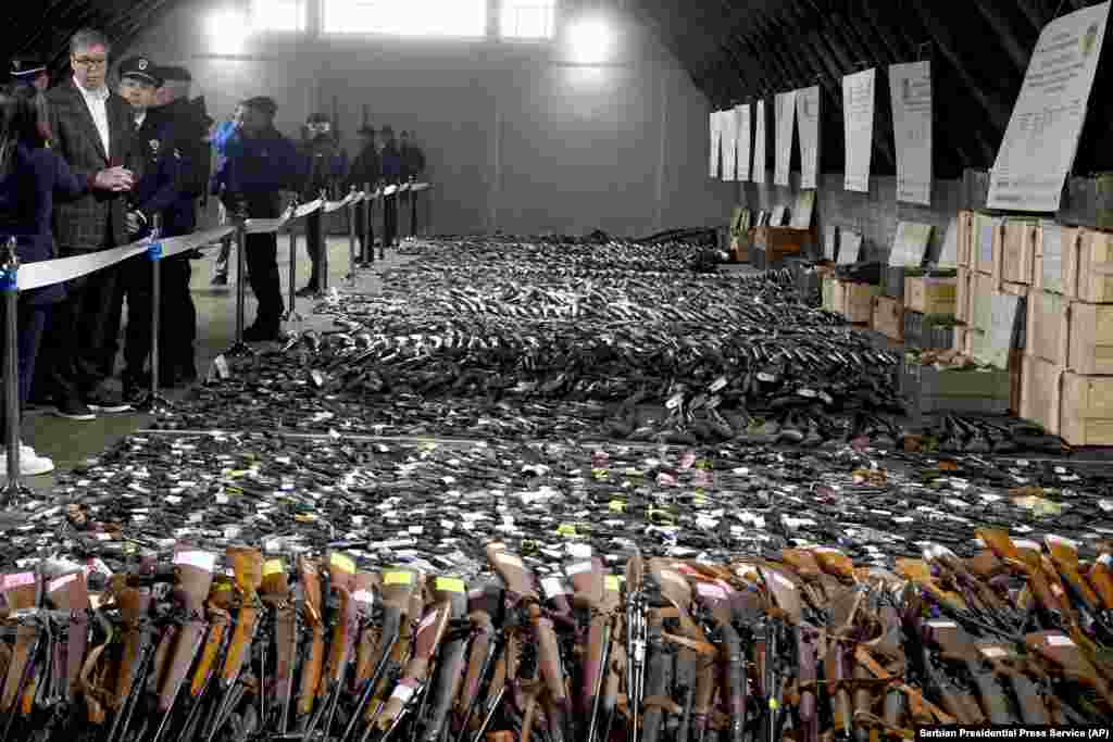 Serbian President Aleksandar Vucic, left, inspects weapons collected as part of an amnesty near the city of Smederevo.