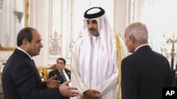 Egyptian President Abdel Fattah el-Sissi, left, and Secretary-General Ahmed Aboul Gheit talk to Qatari Emir Sheikh Tamim bin Hamad Al Thani, during the International peace summit in Cairo, Egypt, on Oct. 21, 2023. (Egyptian Presidency Media Office via AP)