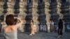 FILE - Tourists from mainland China dressed in traditional Thai costumes visit Wat Arun temple in Bangkok, Thailand, Jan. 18, 2023.