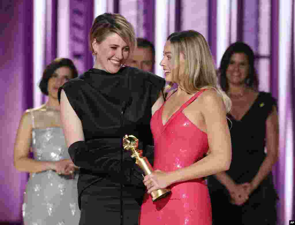 This image released by CBS shows co-director Greta Gerwig, left, and actor Margot Robbie accepting the award for best cinematic and box office achievement for the film &quot;Barbie&quot; during the 81st Annual Golden Globe Awards in Beverly Hills, Calif., on Sunday, Jan. 7, 2024.