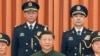 Chinese President Xi Jinping, center, poses for a photo with the new commander of China's rocket force Gen. Wang Houbin, top left, and its political commissar Gen. Xu Xisheng, top right, in Beijing, July 31, 2023. (Li Gang/Xinhua via AP)