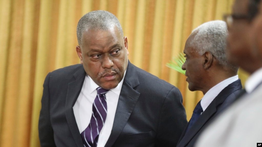 New Haitian Prime Minister Garry Conille, left, speaks to the president of the council Edgard Leblanc Fils during his swearing-in ceremony in Port-au-Prince, Haiti, June 3, 2024.