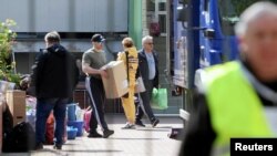 Items are loaded onto a truck as people leave the building of the Russian embassy school in Warsaw, Poland, April 29, 2023. (Kuba Atys/Agencja Wyborcza.pl via Reuters)