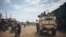 FILE - United Nations South African peacekeepers patrol a street in Oicha where an attack took place in a nearby village the day before, Jan. 29, 2020. 