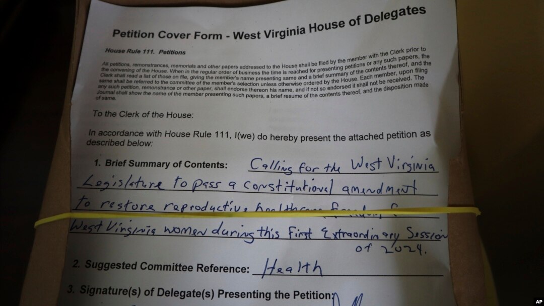 A petition to put abortion access on the ballot in West Virginia sits in the empty House of Delegates chamber, June 21, 2024, at the Capitol in Charleston, West Virginia.
