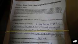 A petition to put abortion access on the ballot in West Virginia sits in the empty House of Delegates chamber, June 21, 2024, at the Capitol in Charleston, West Virginia.