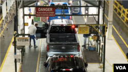 Final checks are done on F-150 vehicles at the Ford Dearborn truck plant in Michigan, February 28, 2024.