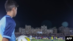 A ball boy watches the final match of a local football tournament at the municipal stadium in Idlib, Syria, Aug. 18, 2023.